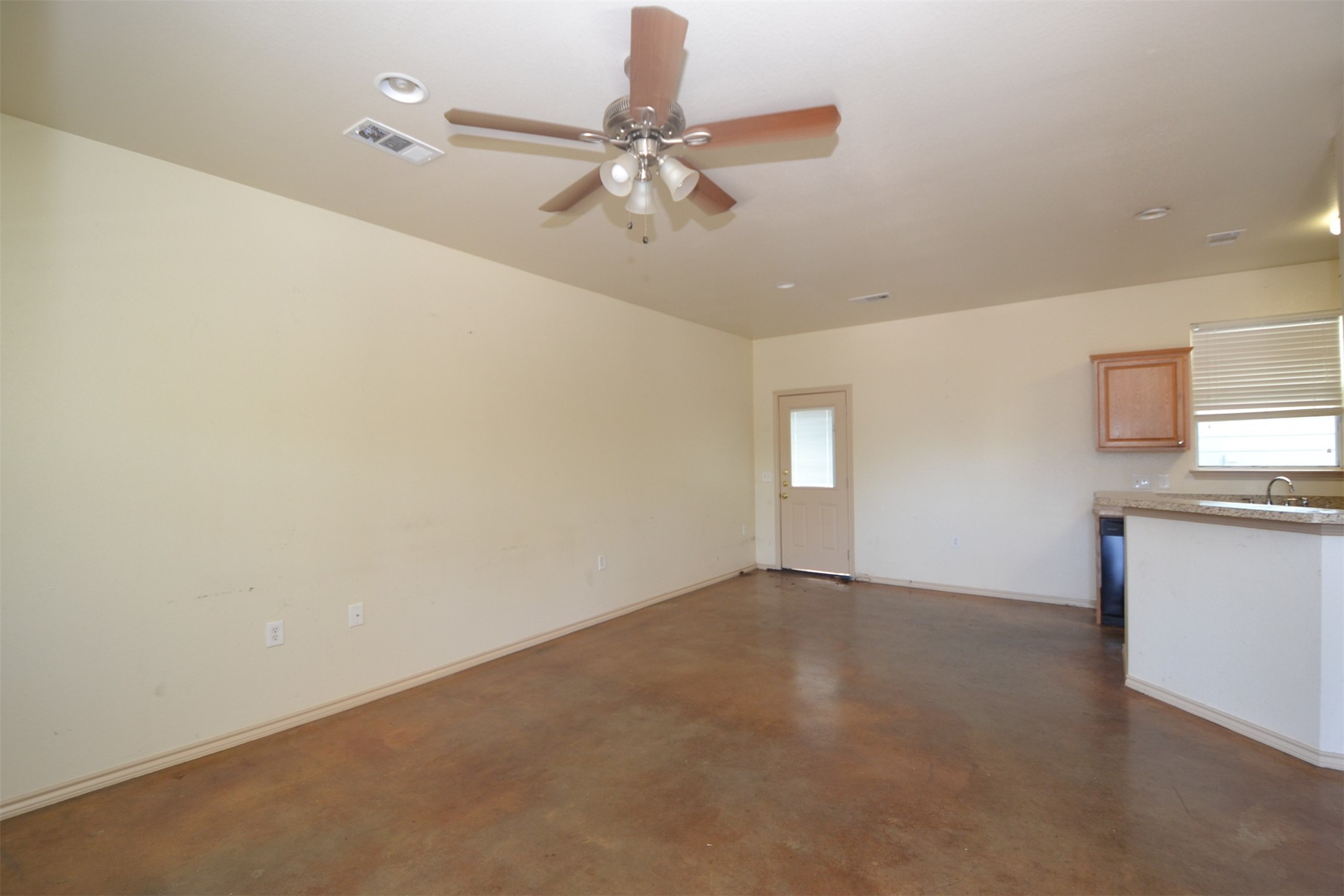 6912 Meador Avenue, Unit A Austin, TX 78752 - Photo 2 of 22 Unfurnished living room featuring finished concrete flooring and ceiling fan