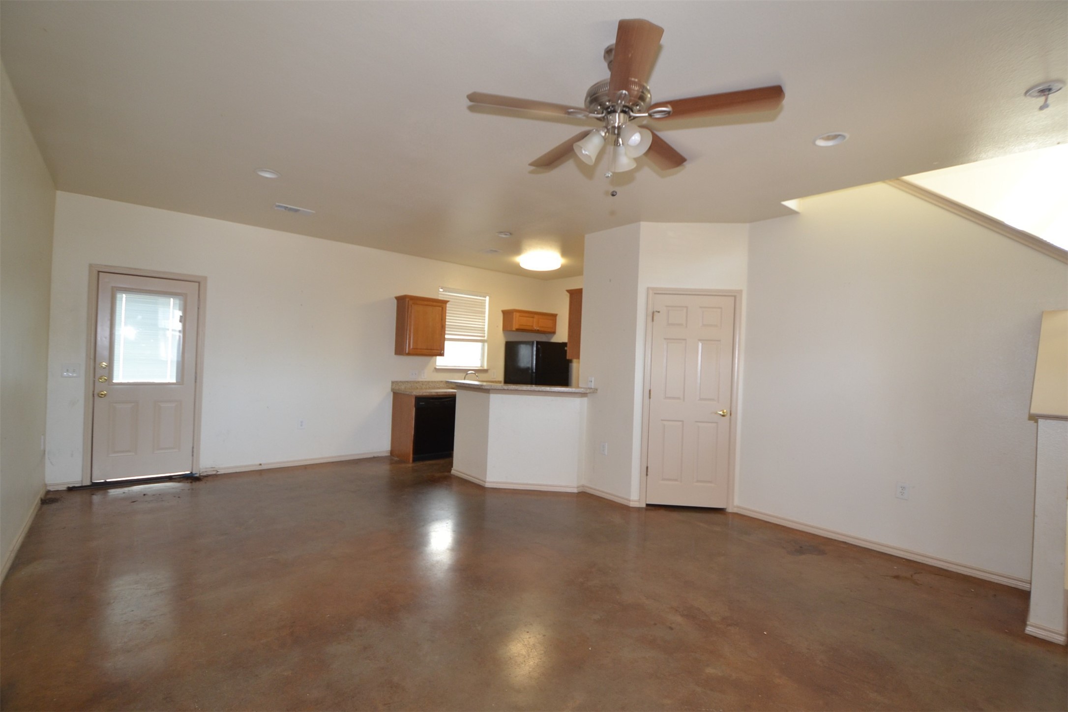 6912 Meador Avenue, Unit A Austin, TX 78752 - Photo 3 of 22 Unfurnished living room featuring a ceiling fan and concrete floors