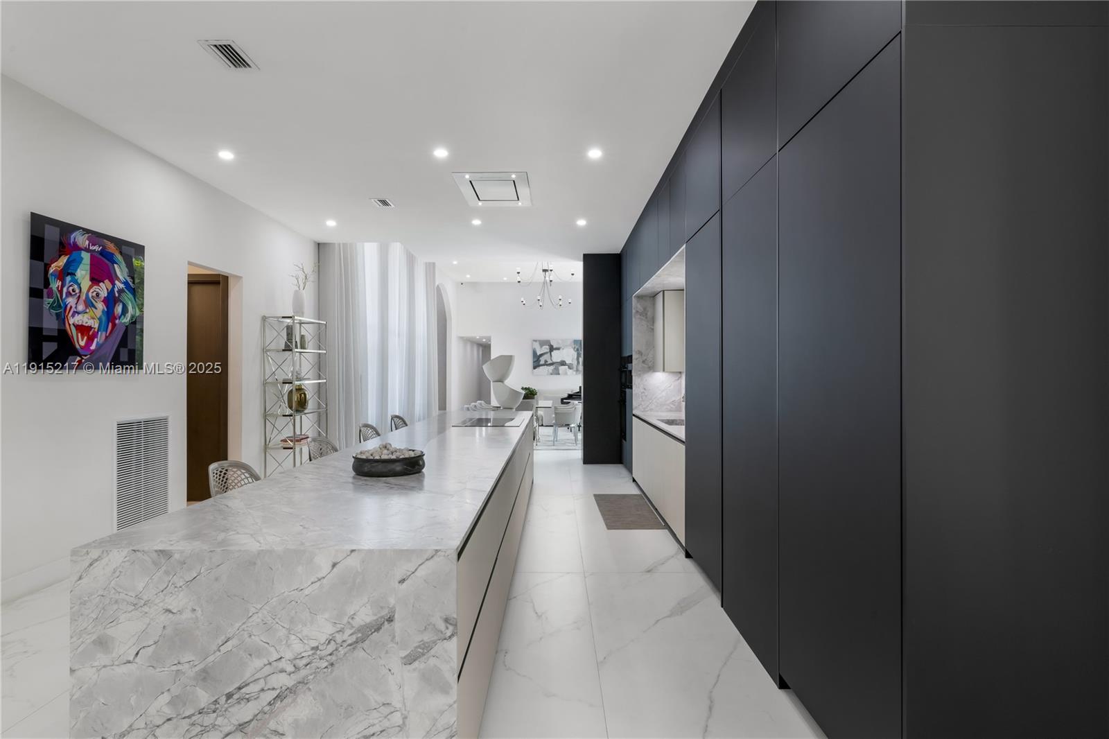 8941 Southwest 65th Court, Unit 8941 Pinecrest, FL 33156 - Photo 14 of 85 a view of a hallway with a couch and a refrigerator