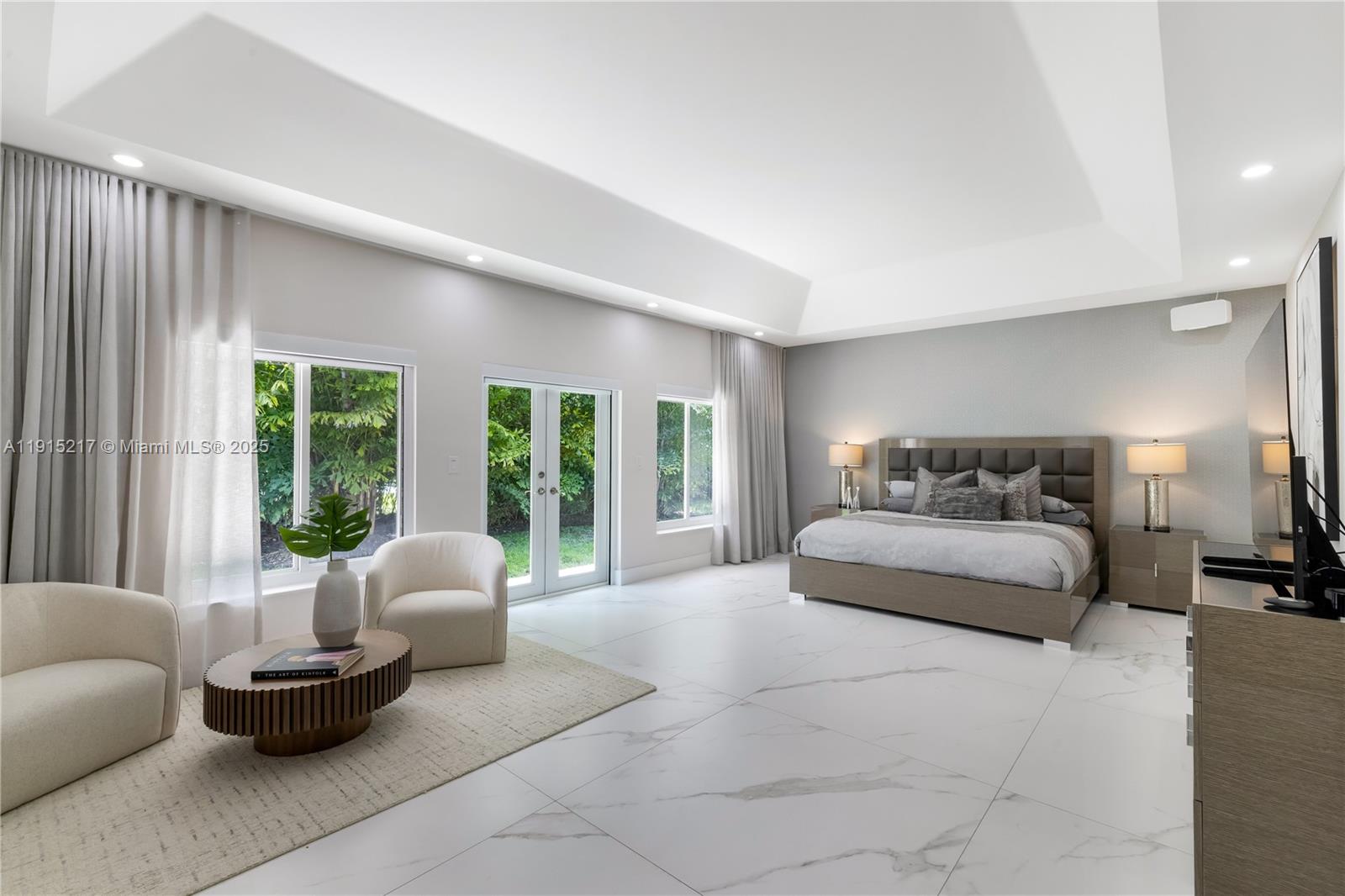 8941 Southwest 65th Court, Unit 8941 Pinecrest, FL 33156 - Photo 22 of 85 a spacious bedroom with a bed and large windows