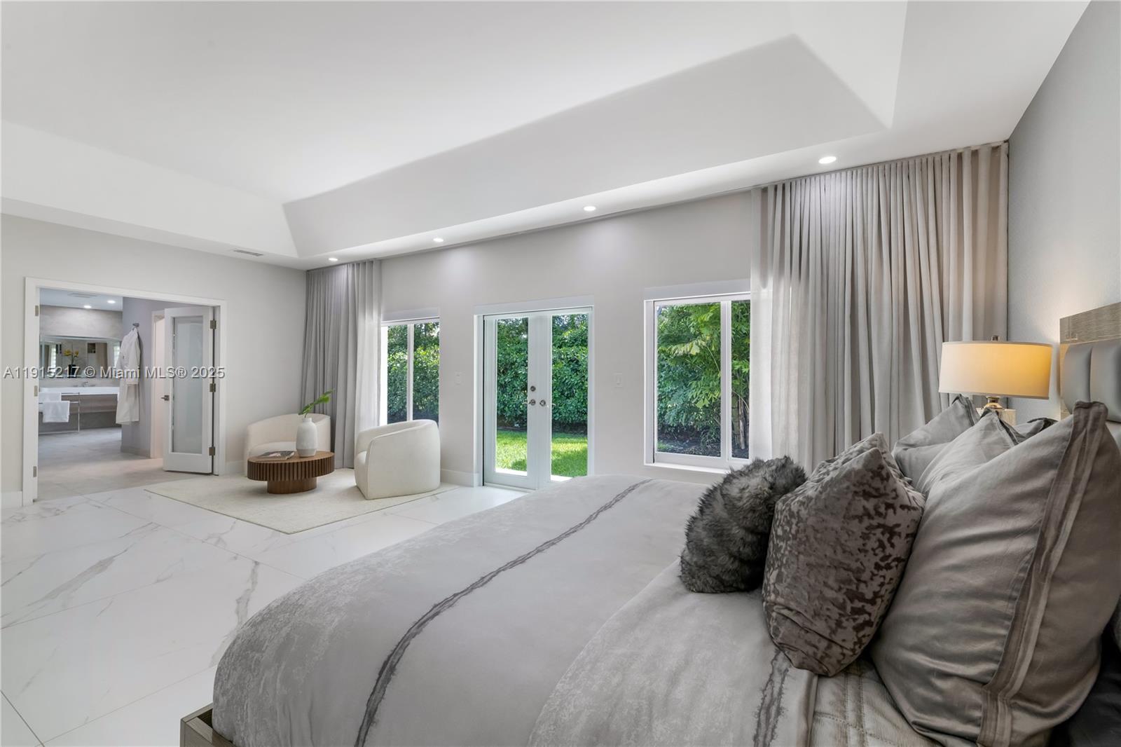 8941 Southwest 65th Court, Unit 8941 Pinecrest, FL 33156 - Photo 23 of 85 a bedroom with a bed and large window