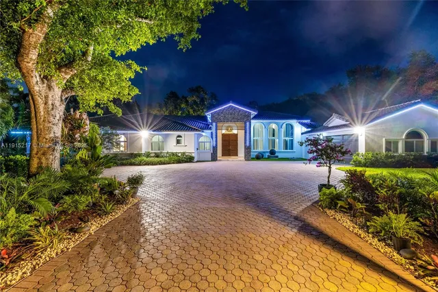 a front view of a house with a yard and a garage