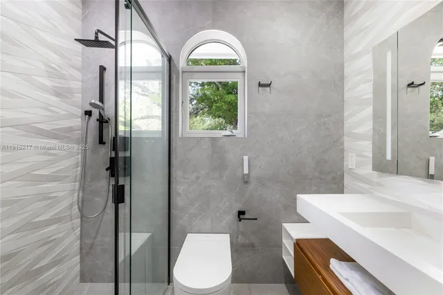 a spacious bedroom with a large bed and a flat screen tv