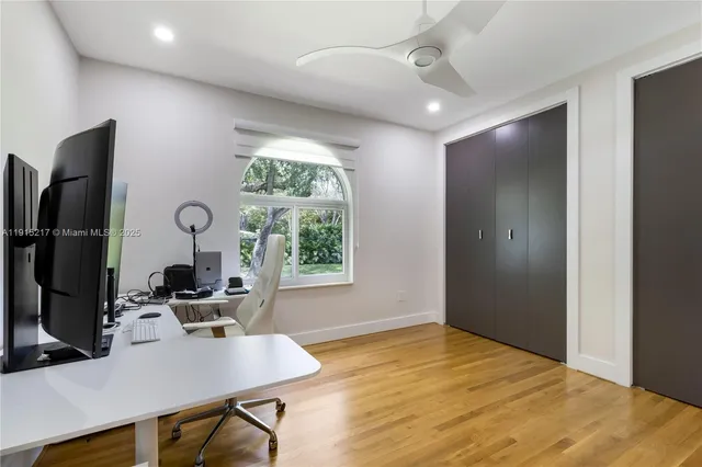 a view of a patio with table and chairs potted plants and wooden floor