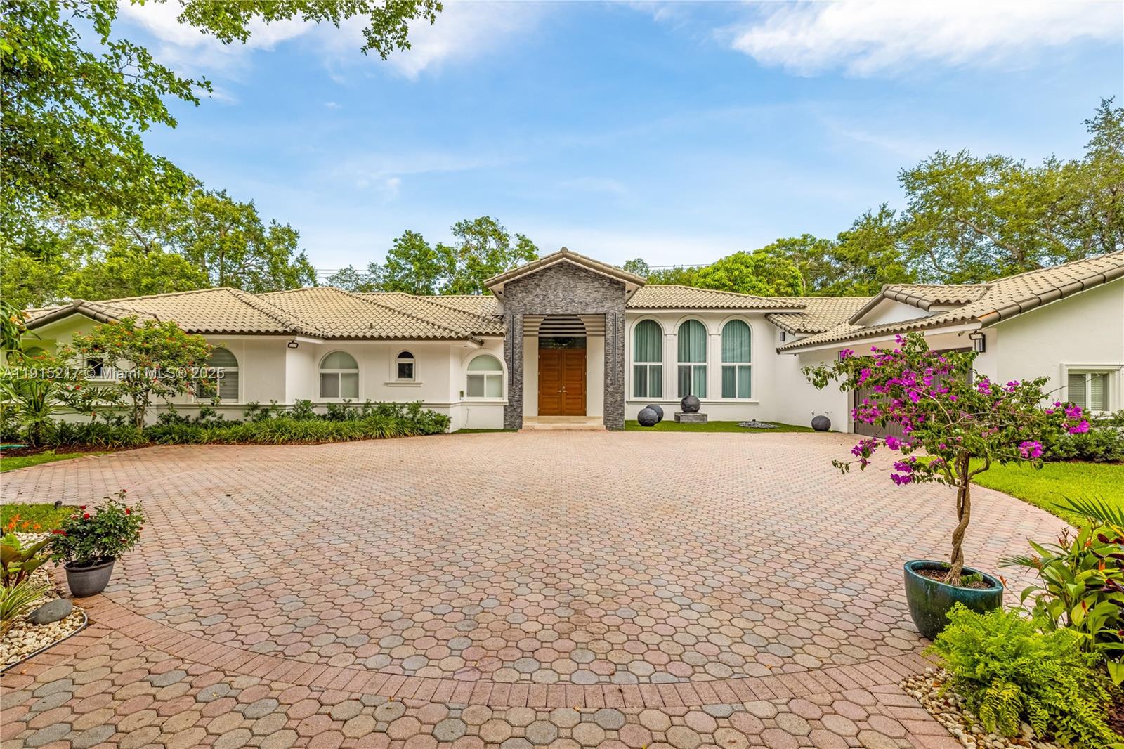 8941 Southwest 65th Court, Unit 8941 Pinecrest, FL 33156 - Photo 4 of 85 a front view of a house with a yard and a garage