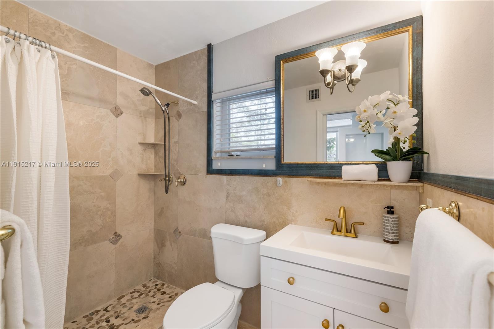 8941 Southwest 65th Court, Unit 8941 Pinecrest, FL 33156 - Photo 45 of 85 a bathroom with a sink a toilet and shower