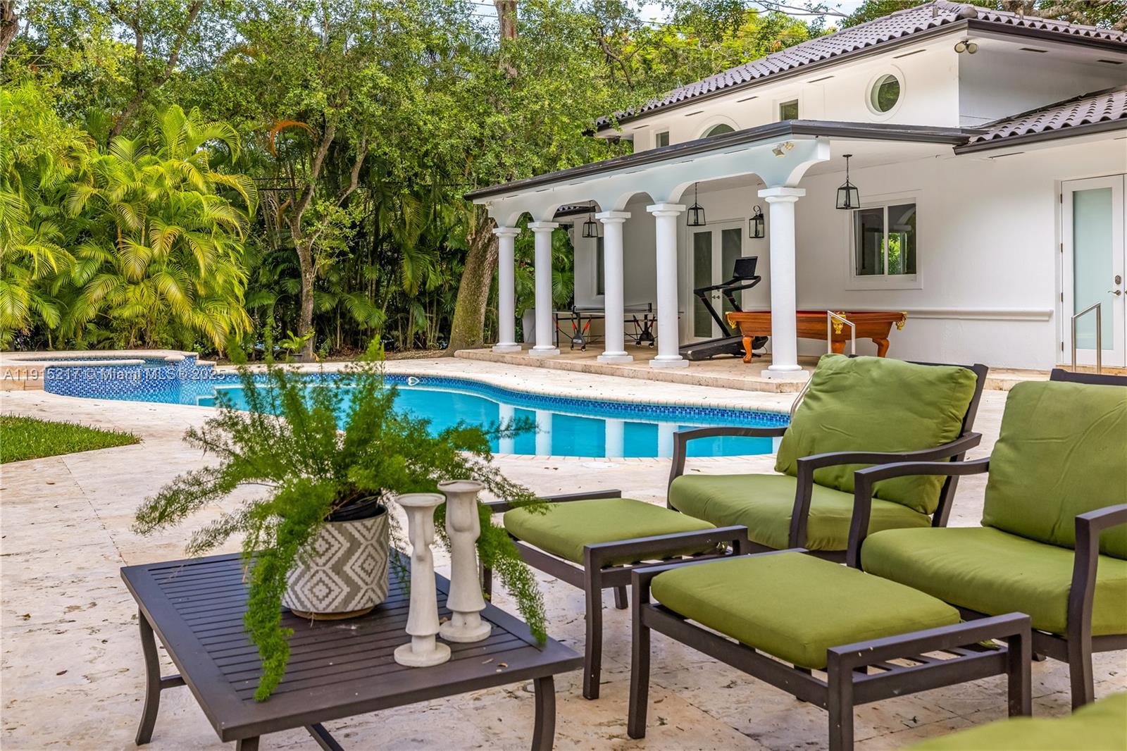 8941 Southwest 65th Court, Unit 8941 Pinecrest, FL 33156 - Photo 55 of 85 a view of a patio with table and chairs potted plants and wooden floor
