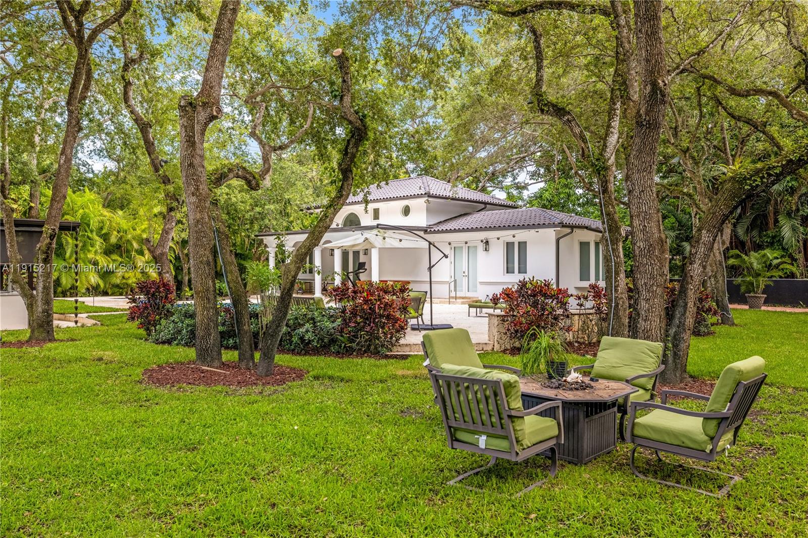 8941 Southwest 65th Court, Unit 8941 Pinecrest, FL 33156 - Photo 60 of 85 a front view of a house with garden and sitting area