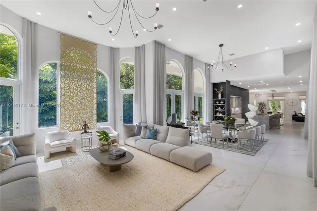 a living room with fireplace furniture and a large window