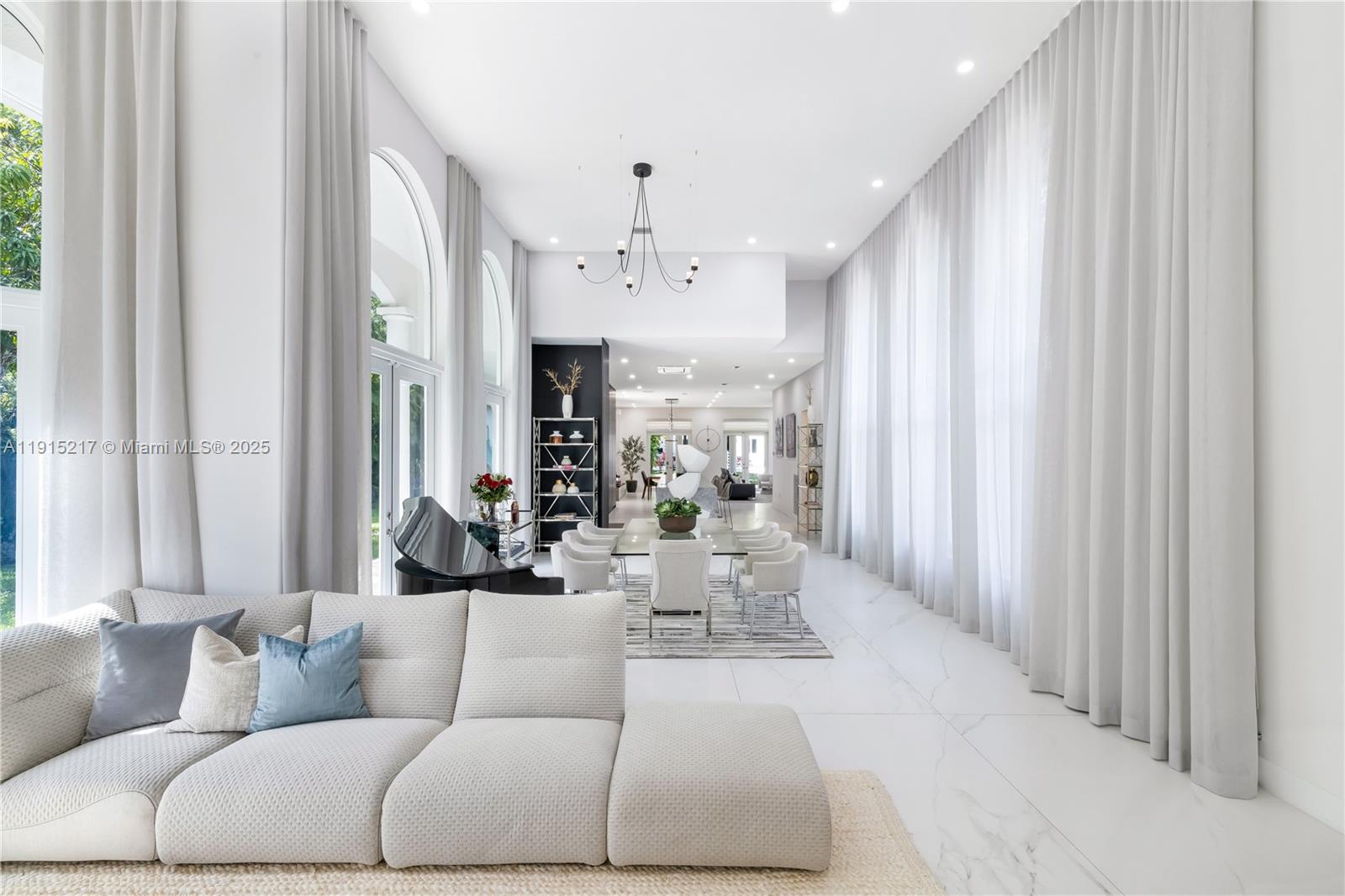 8941 Southwest 65th Court, Unit 8941 Pinecrest, FL 33156 - Photo 7 of 85 a living room with furniture and a chandelier