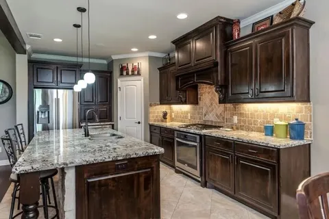 a kitchen with granite countertop stainless steel appliances and wooden cabinets