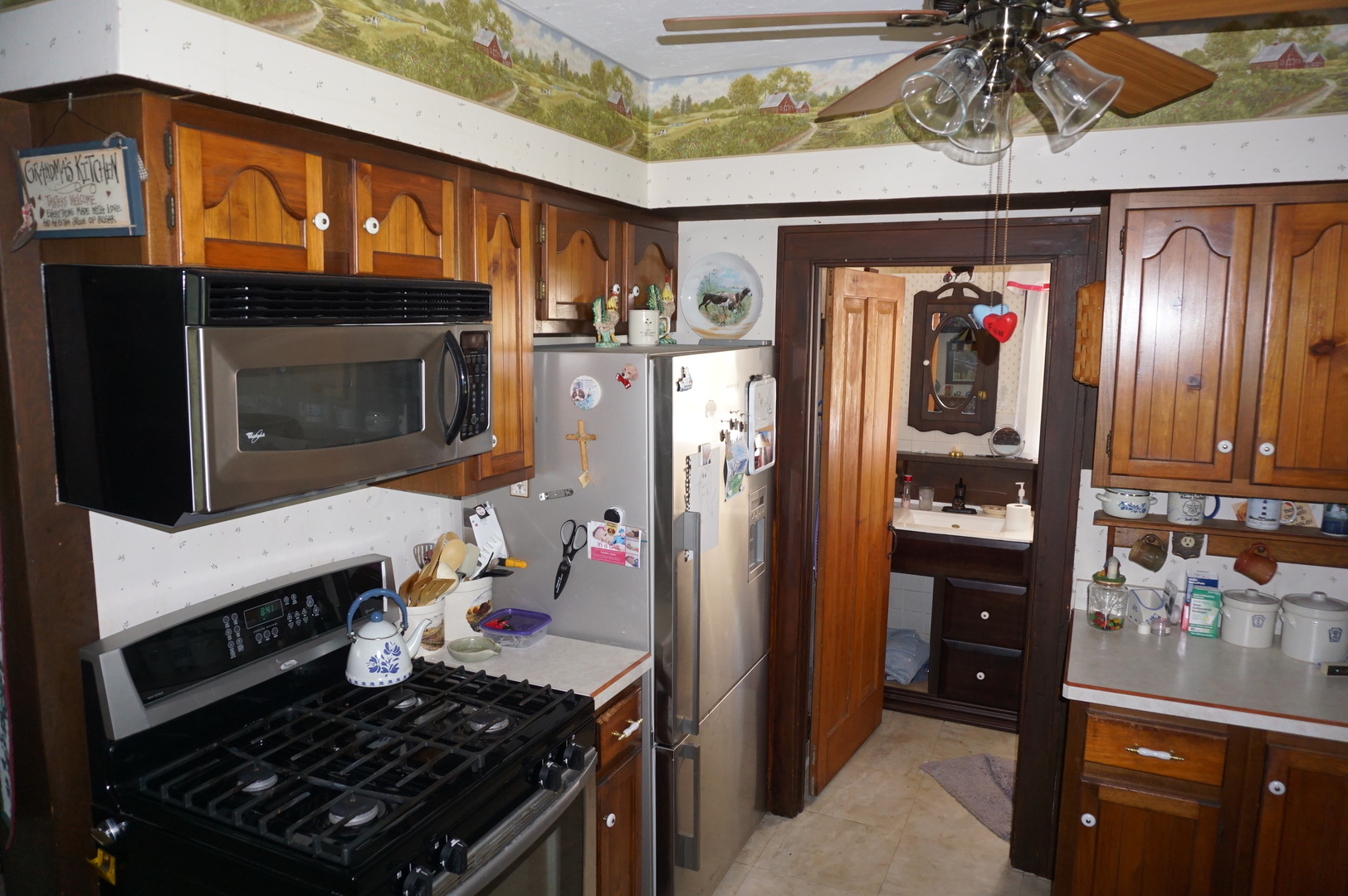 1924 East 6000th Road South St. Anne, IL 60964 - Photo 8 of 35 a kitchen with a wooden floor and a fireplace