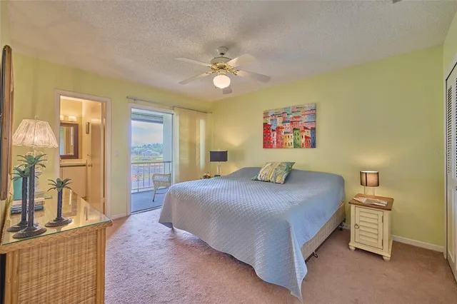 a bedroom with a bed and dresser with mirror