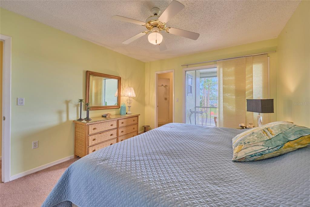 3647 Edgewater Drive Sebring, FL 33872 - Photo 22 of 54 a bedroom with a bed and a chandelier
