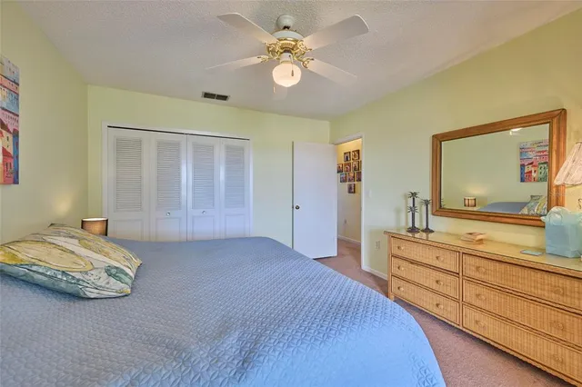 a spacious bedroom with a bed and a chandelier