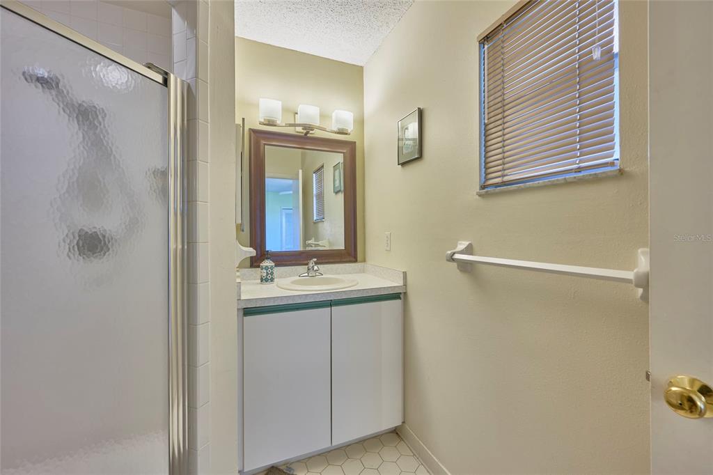 3647 Edgewater Drive Sebring, FL 33872 - Photo 26 of 54 a bathroom with a granite countertop shower a sink and mirror