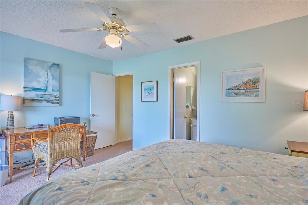3647 Edgewater Drive Sebring, FL 33872 - Photo 27 of 54 a bedroom with a bed and a chandelier