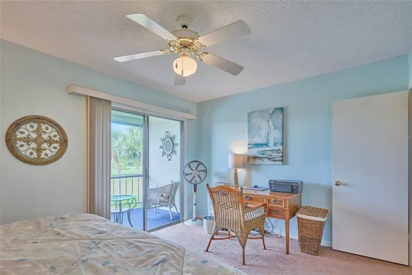 a bedroom with a bed a chandelier and a window