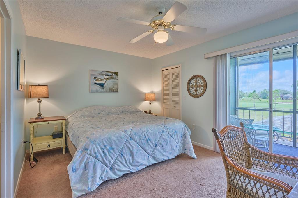 3647 Edgewater Drive Sebring, FL 33872 - Photo 29 of 54 a bedroom with a bed a chandelier and a window