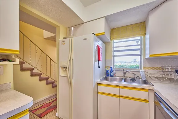 a view of a bedroom with wooden floor and windows