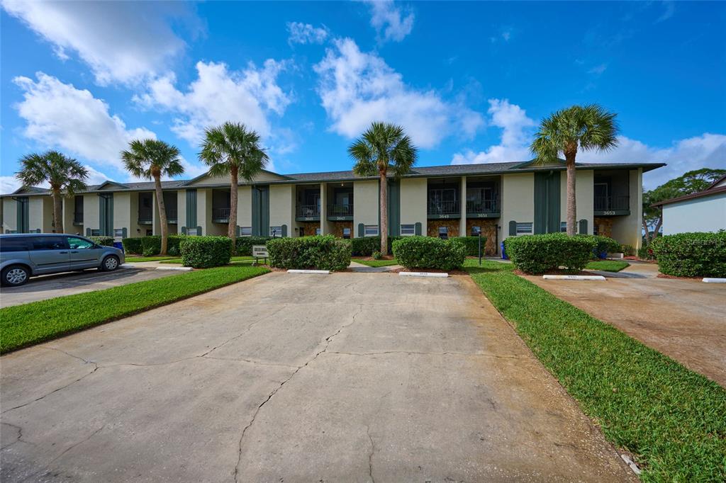 3647 Edgewater Drive Sebring, FL 33872 - Photo 42 of 54 a view of a white house with a yard and potted plants