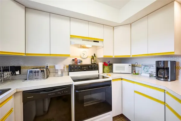 a kitchen with stainless steel appliances granite countertop a sink and a stove