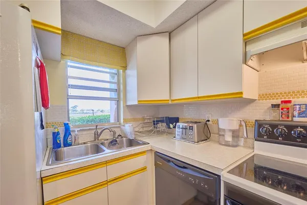 a kitchen with sink and window