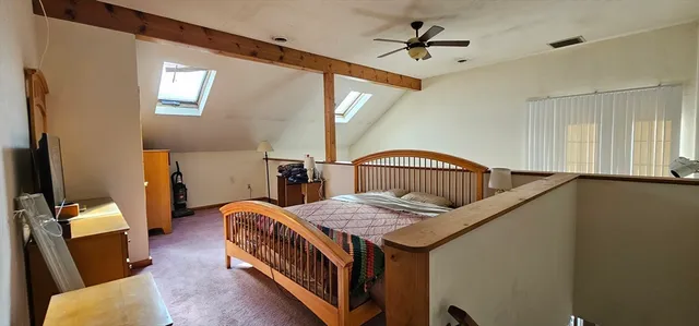 a bedroom with furniture and a window