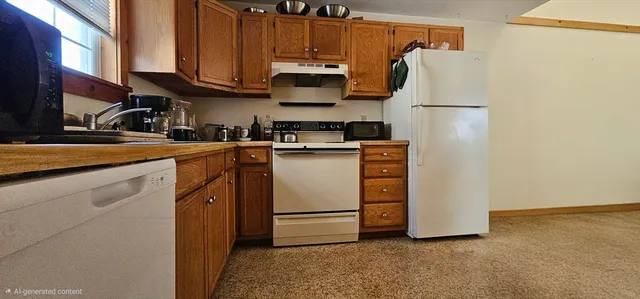 a kitchen with appliances a sink and cabinets
