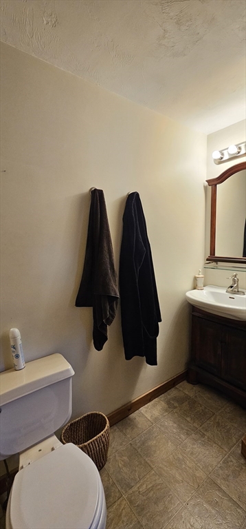 191 City Depot Road, Unit A Charlton, MA 01507 - Photo 6 of 12 a bathroom with a toilet sink and mirror