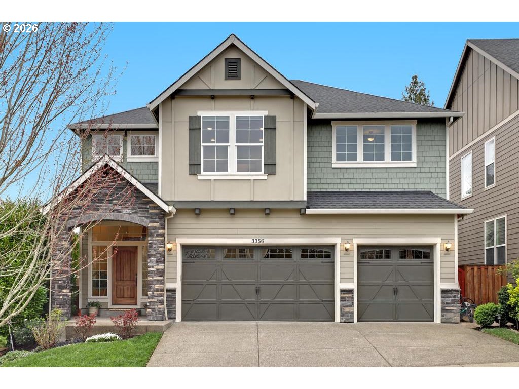 3356 Northwest 153rd Terrace Portland, OR 97229 - Photo 1 of 24 a front view of a house with a yard and garage