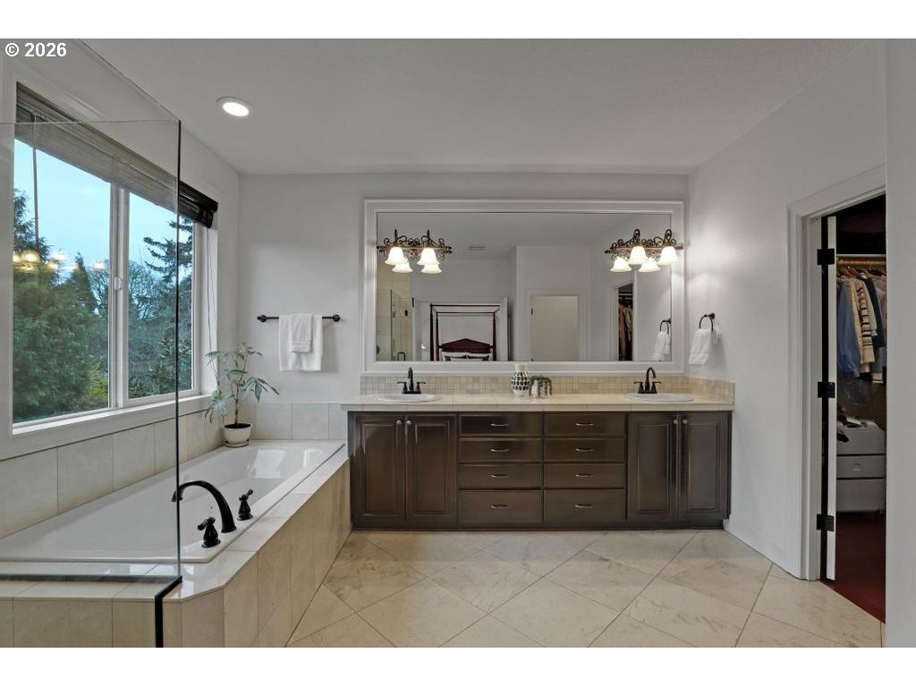 3356 Northwest 153rd Terrace Portland, OR 97229 - Photo 12 of 24 a bathroom with a sink double vanity granite tub shower and a mirror