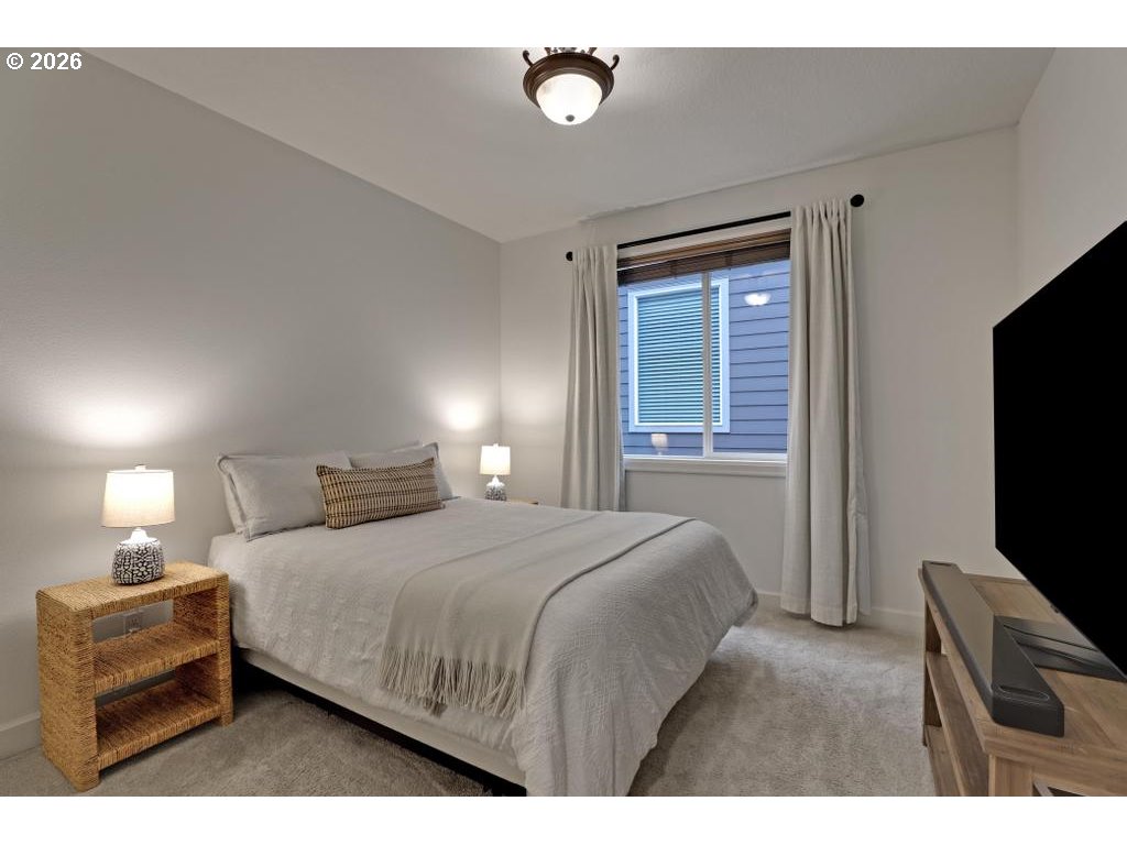 3356 Northwest 153rd Terrace Portland, OR 97229 - Photo 15 of 24 a bedroom with a bed and a flat tv screen on dresser