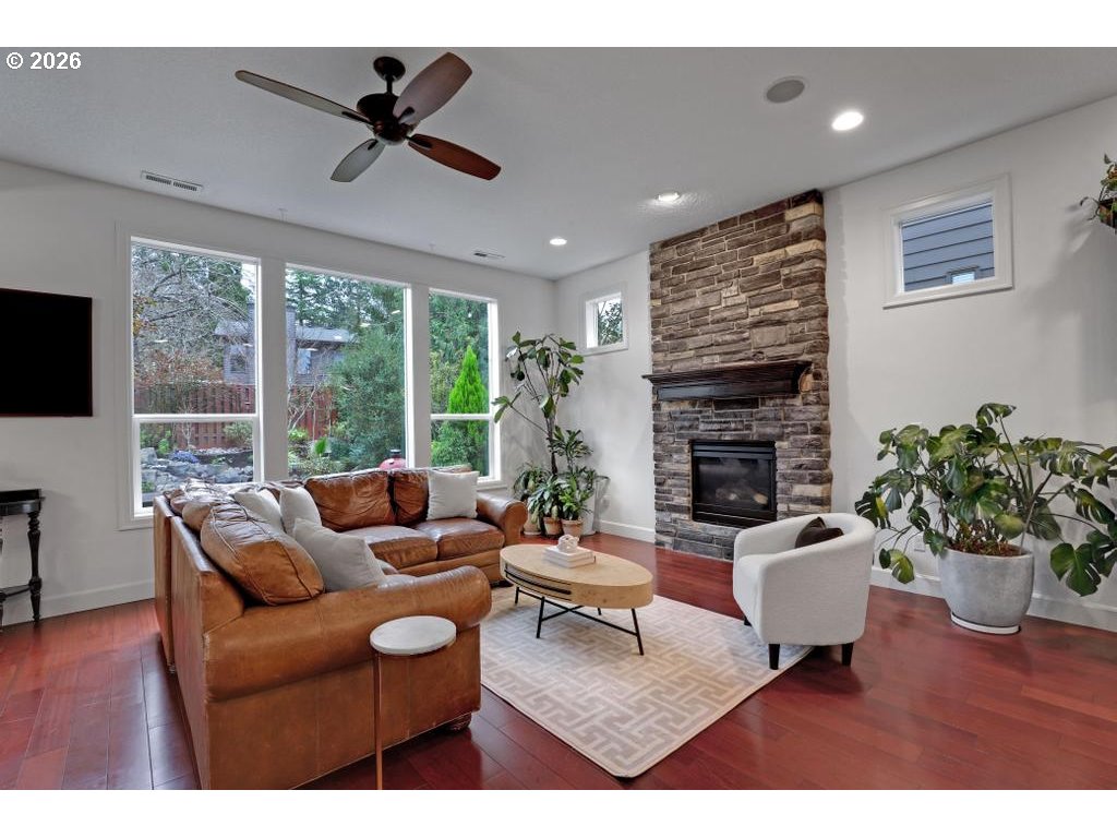 3356 Northwest 153rd Terrace Portland, OR 97229 - Photo 3 of 24 a living room with furniture a fireplace and a flat screen tv
