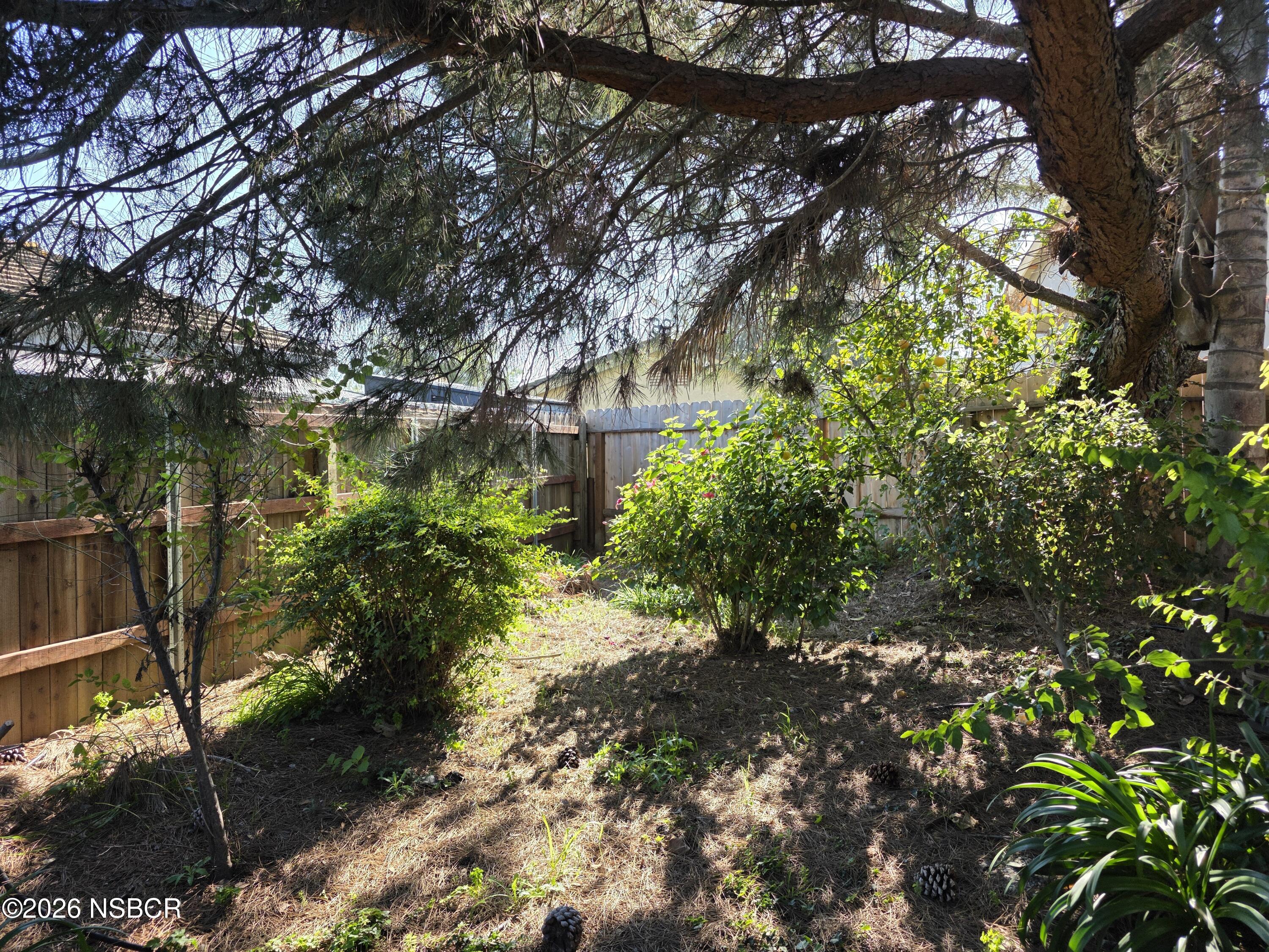 1112 Rachel Drive Santa Maria, CA 93454 - Photo 23 of 23 a backyard of a house with a yard and outdoor seating