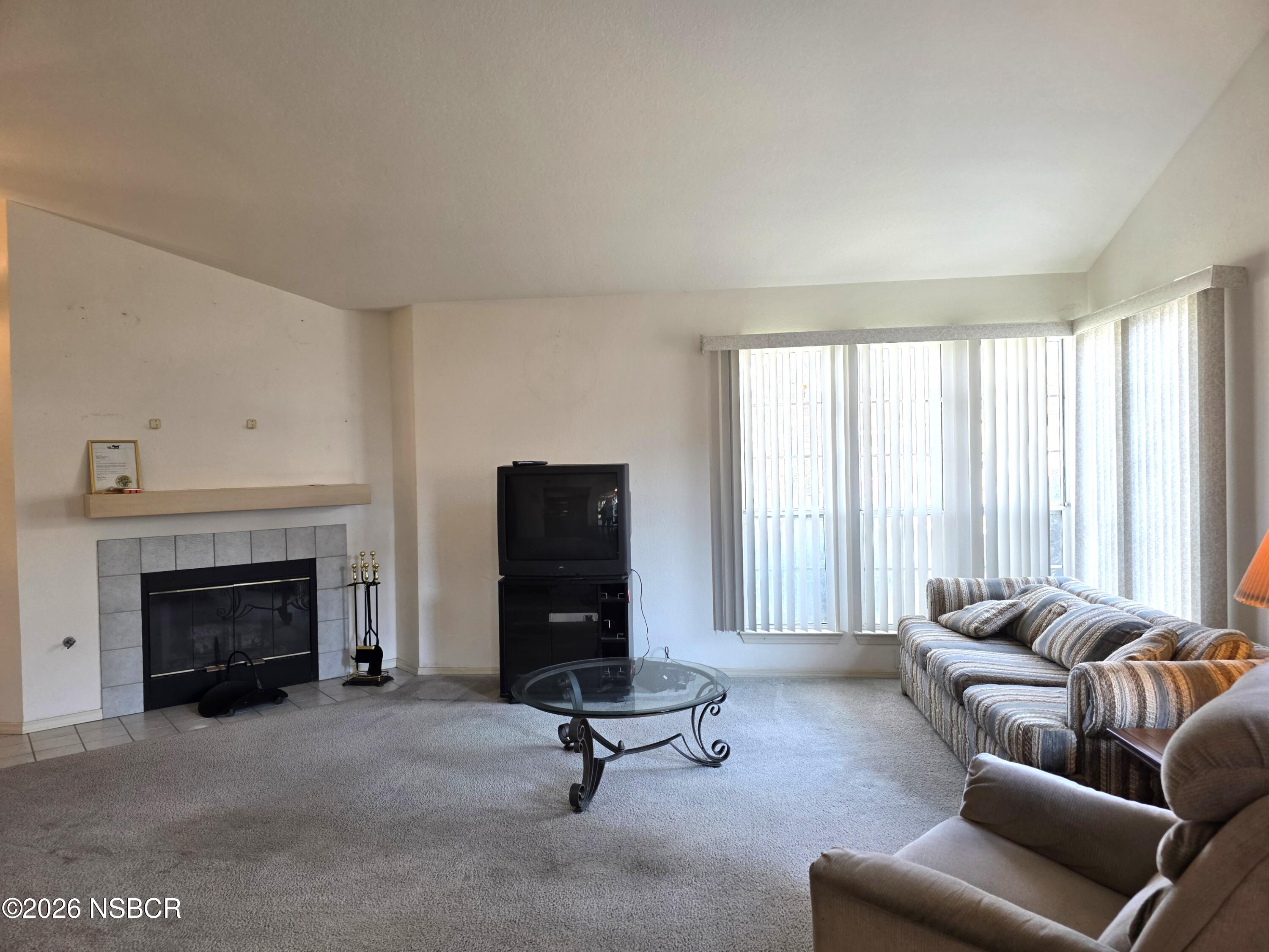 1112 Rachel Drive Santa Maria, CA 93454 - Photo 5 of 23 a living room with furniture a fireplace and a large window