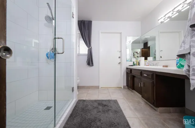 a room with a refrigerator a sink and cabinets