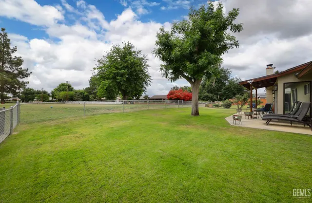 a view of a swimming pool with a yard