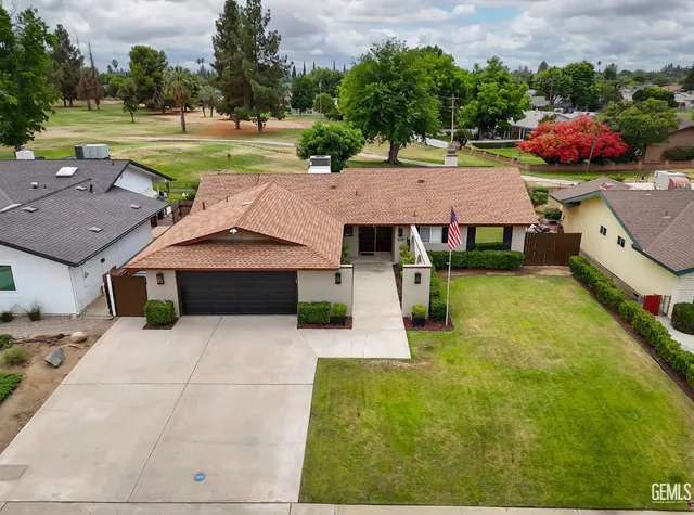 an aerial view of a house with big yard