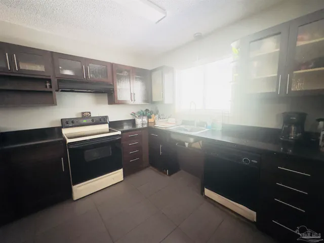 a kitchen with a sink stove and cabinets
