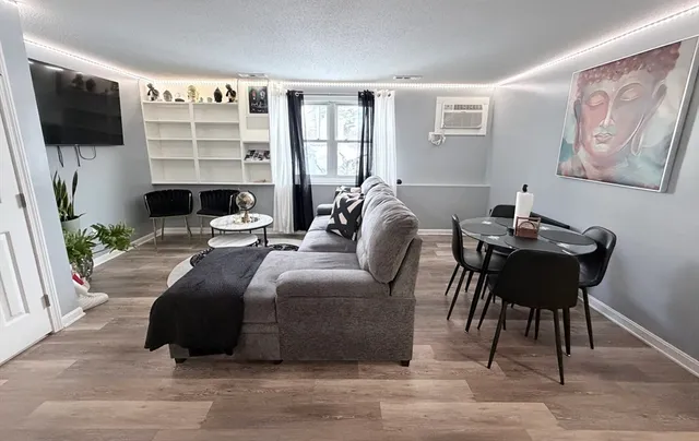 a living room with furniture a flat screen tv and a fireplace