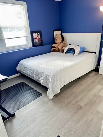 a bedroom with bed and window