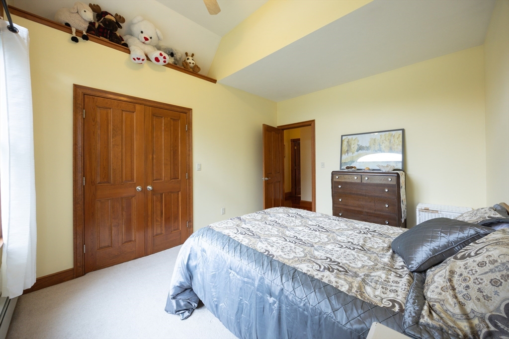 70 Azalea Way Hanson, MA 02341 - Photo 35 of 42 a bedroom with a bed and a dresser