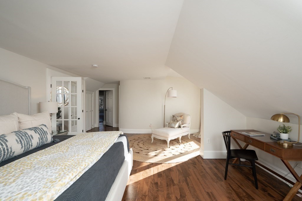 25 Mill Lane Hingham, MA 02043 - Photo 14 of 26 a spacious bedroom with a bed and a table in it