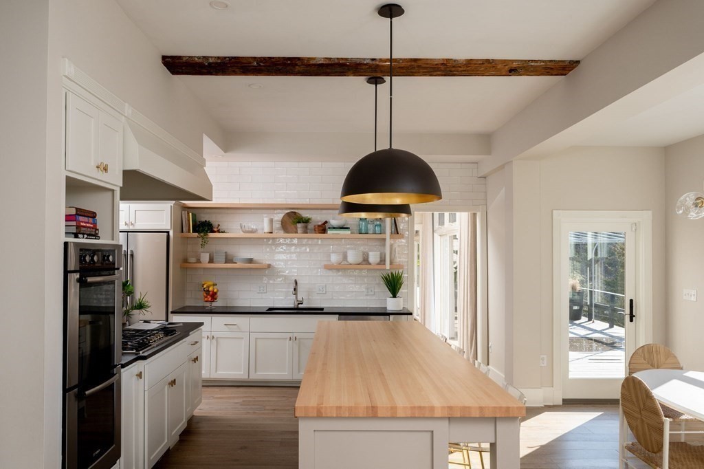 25 Mill Lane Hingham, MA 02043 - Photo 6 of 26 a kitchen with stainless steel appliances granite countertop a sink a stove and a wooden floors