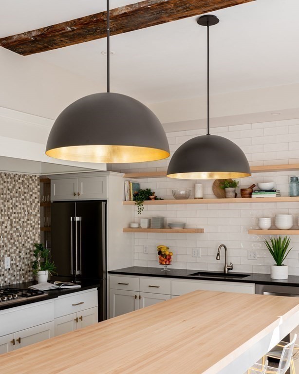 25 Mill Lane Hingham, MA 02043 - Photo 7 of 26 a kitchen with stainless steel appliances kitchen island granite countertop a sink a stove and a refrigerator