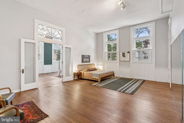 a living room with furniture rug and window