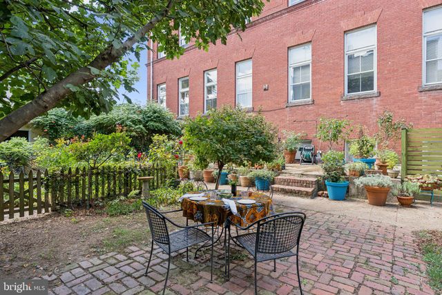 a view of a house with a yard and garden