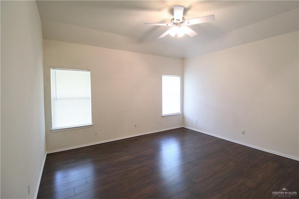 8202 North 22nd Lane McAllen, TX 78504 - Photo 11 of 25 an empty room with wooden floor and windows