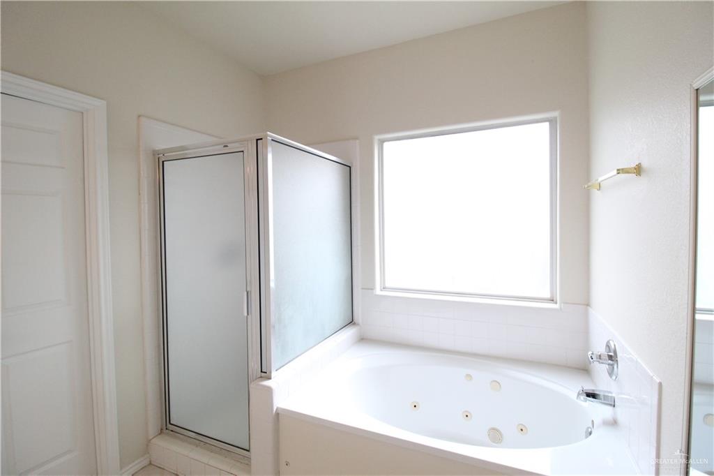 8202 North 22nd Lane McAllen, TX 78504 - Photo 13 of 25 a white bath tub sitting next to a window
